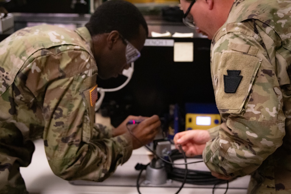 National Guard Helicopter Crew Chiefs conduct Maintenance on Black Hawk Helicopters