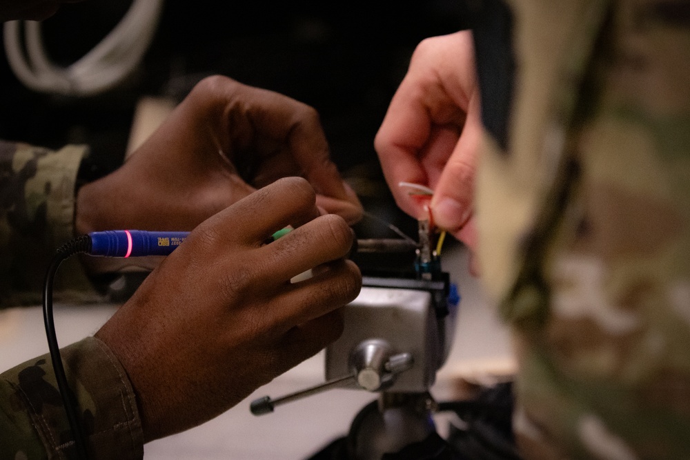 National Guard Helicopter Crew Chiefs conduct Maitenance on Black Hawk Helicopters