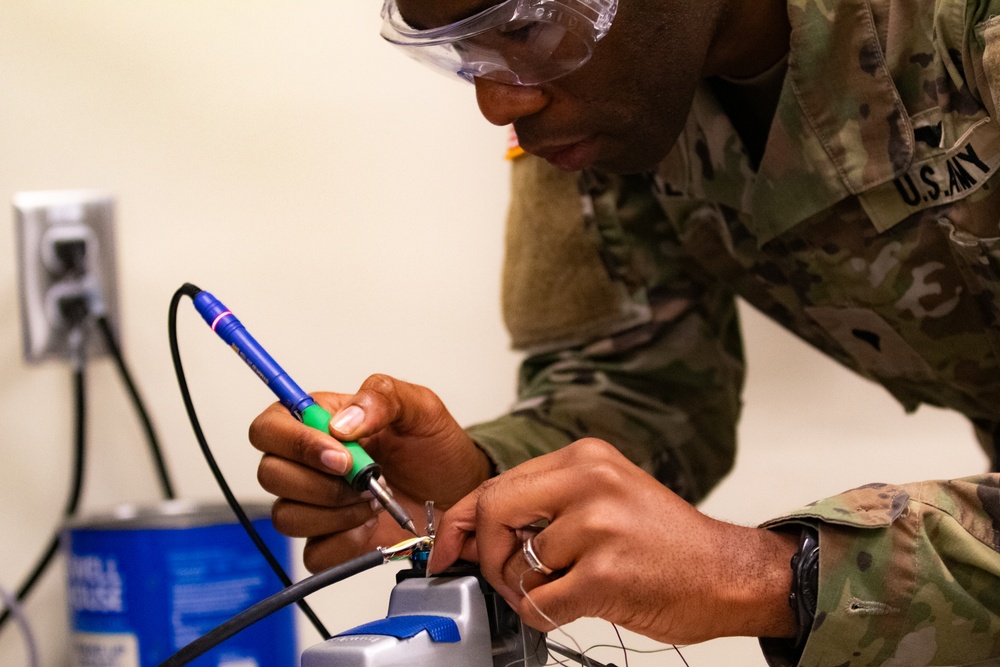 National Guard Helicopter Crew Chiefs conduct Maitenance on Black Hawk Helicopters