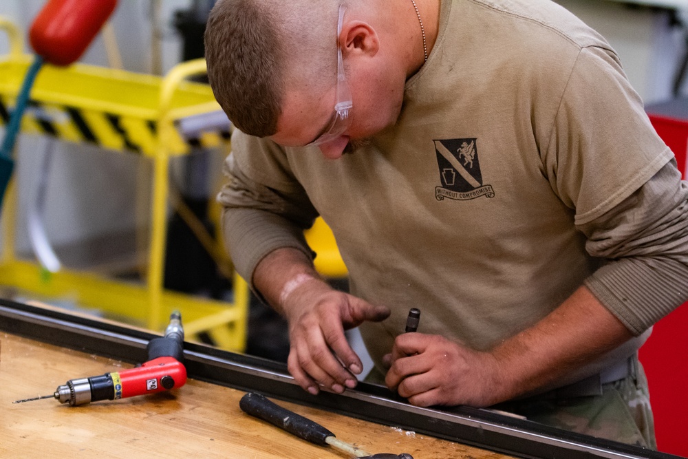 National Guard Helicopter Crew Chiefs conduct Maintenance on Black Hawk Helicopters