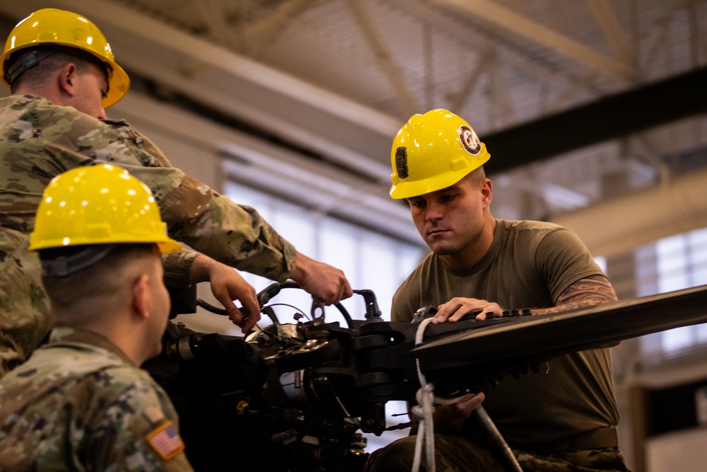 National Guard Helicopter Crew Chiefs conduct Maintenance on Black Hawk Helicopters