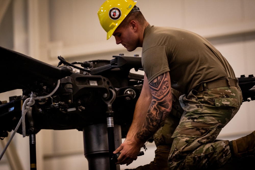 National Guard Helicopter Crew Chiefs conduct Maintenance on Black Hawk Helicopters