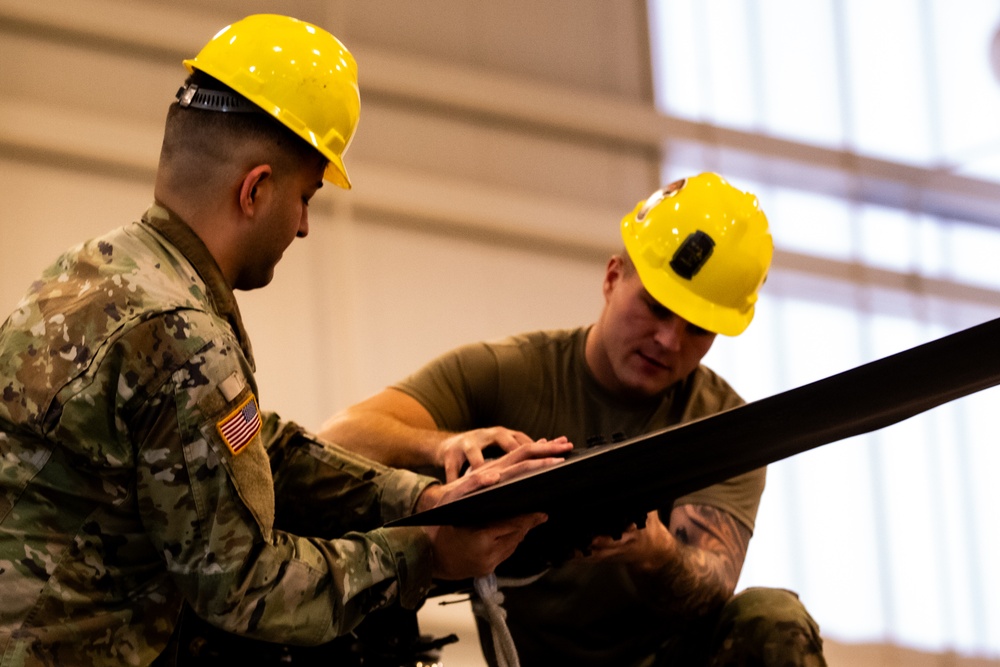 National Guard Helicopter Crew Chiefs conduct Maitenance on Black Hawk Helicopters