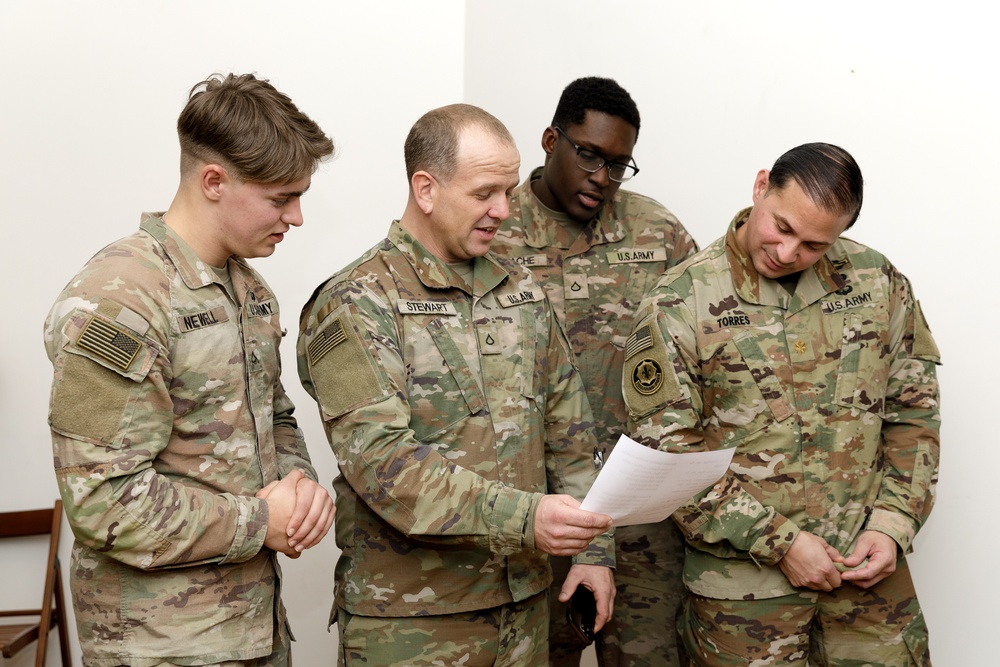 3rd Infantry Division Artillery Soldiers carol and serve food at Latvian church