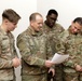 3rd Infantry Division Artillery Soldiers carol and serve food at Latvian church