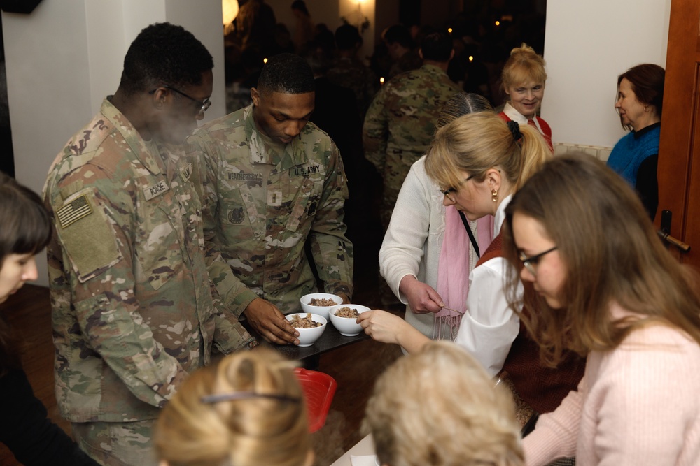 3rd Infantry Division Artillery Soldiers carol and serve food at Latvian church