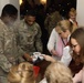 3rd Infantry Division Artillery Soldiers carol and serve food at Latvian church