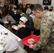 3rd Infantry Division Artillery Soldiers carol and serve food at Latvian church