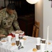 3rd Infantry Division Artillery Soldiers carol and serve food at Latvian church