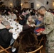 3rd Infantry Division Artillery Soldiers carol and serve food at Latvian church