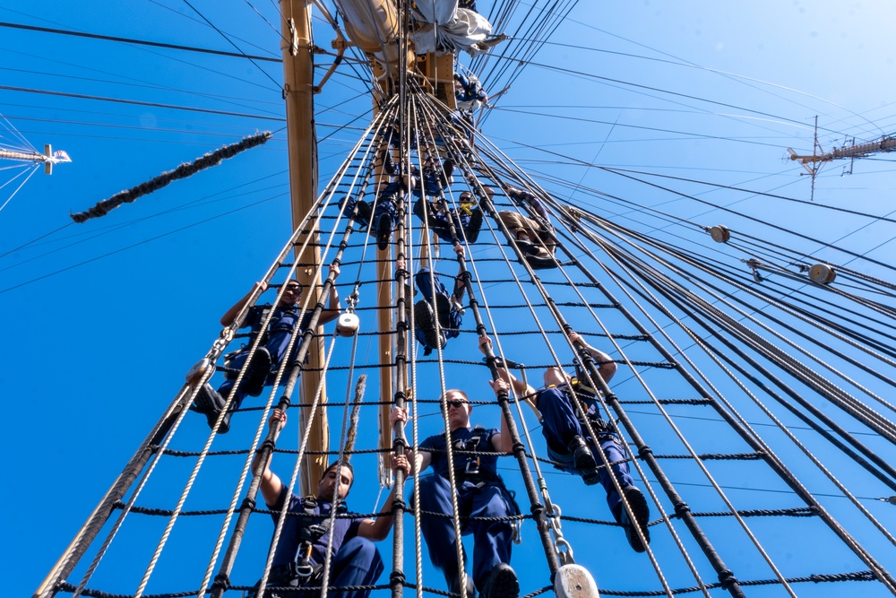 Coast Guard officer candidates climb mast of CGC Barque Eagle