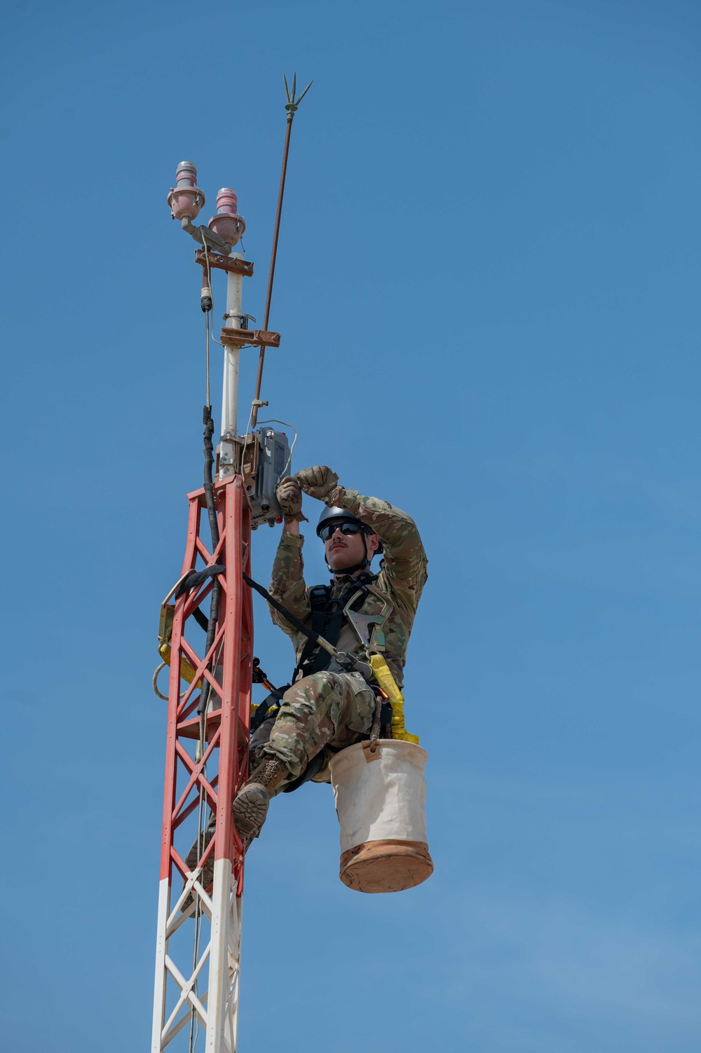Weather and Engineering Installation Airmen perform maintenance on a weather sensor