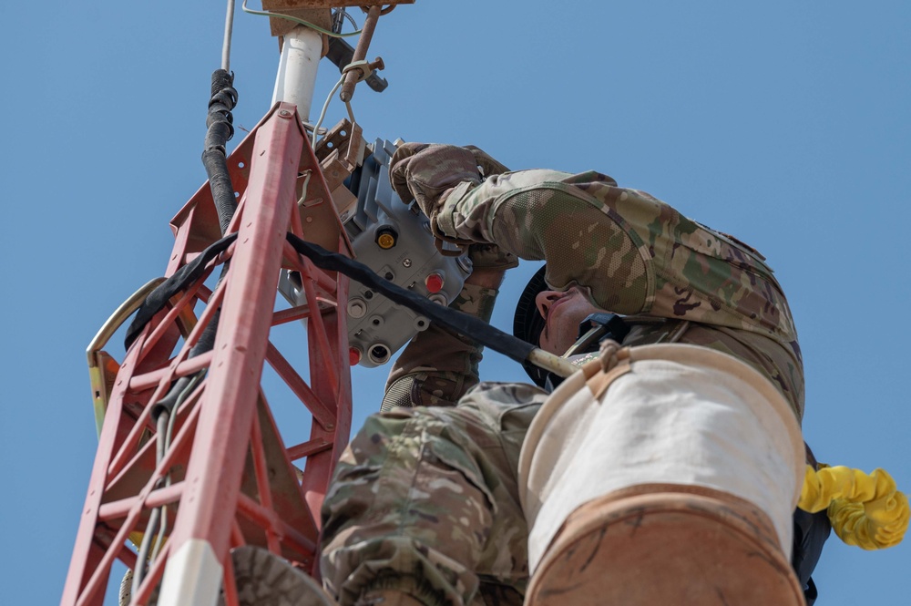 Weather and Engineering Installation Airmen perform maintenance on a weather sensor