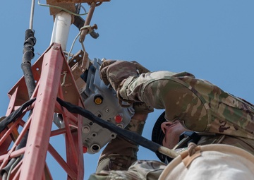 Weather and Engineering Installation Airmen perform maintenance on a weather sensor