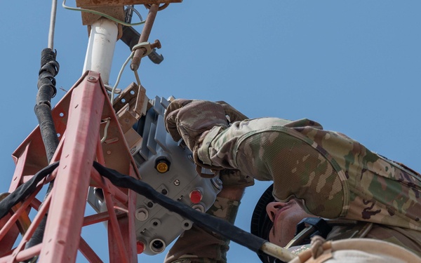 Weather and Engineering Installation Airmen perform maintenance on a weather sensor