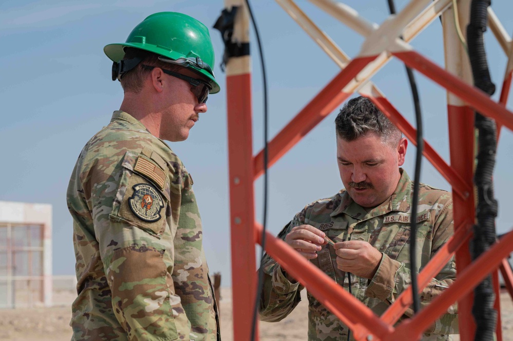 Weather and Engineering Installation Airmen perform maintenance on a weather sensor