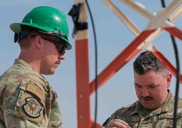 Weather and Engineering Installation Airmen perform maintenance on a weather sensor