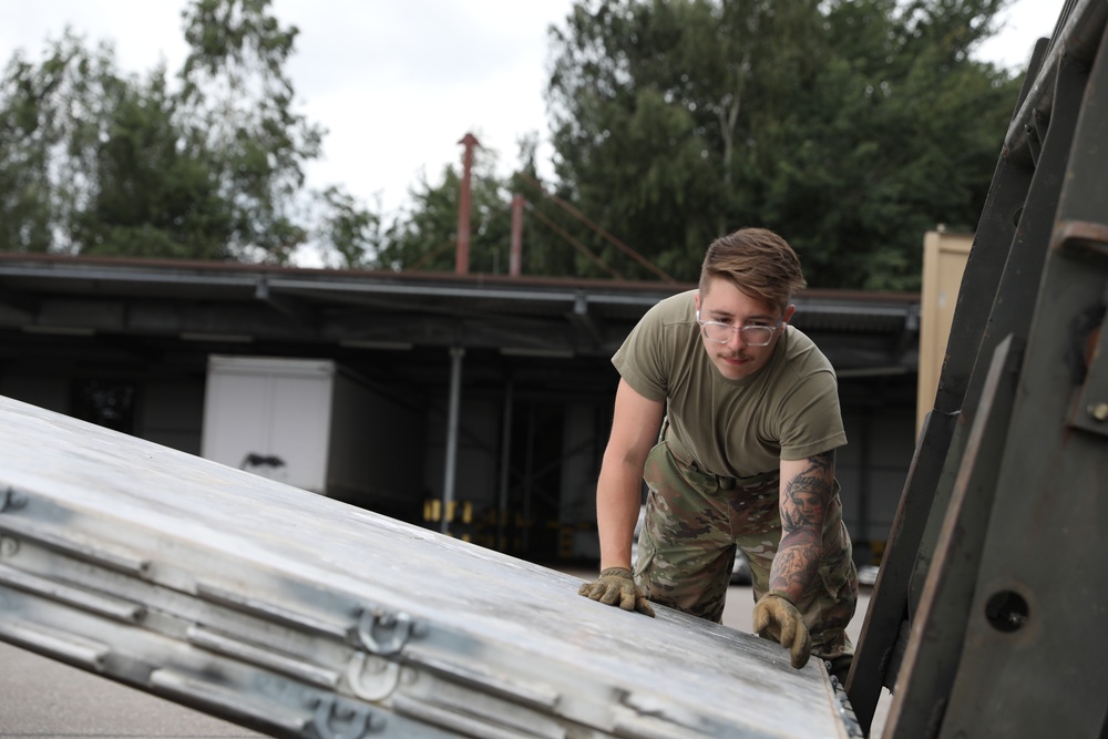 Airmen from the 87th and 721st Aerial Port Squadrons move explosive cargo at Ramstein Air Base, Germany