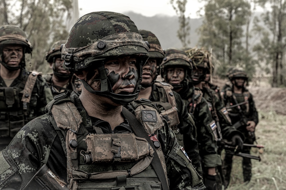 Photo Illustrations of US and British Advisors with RTA Soldiers during JPMRC 24-1