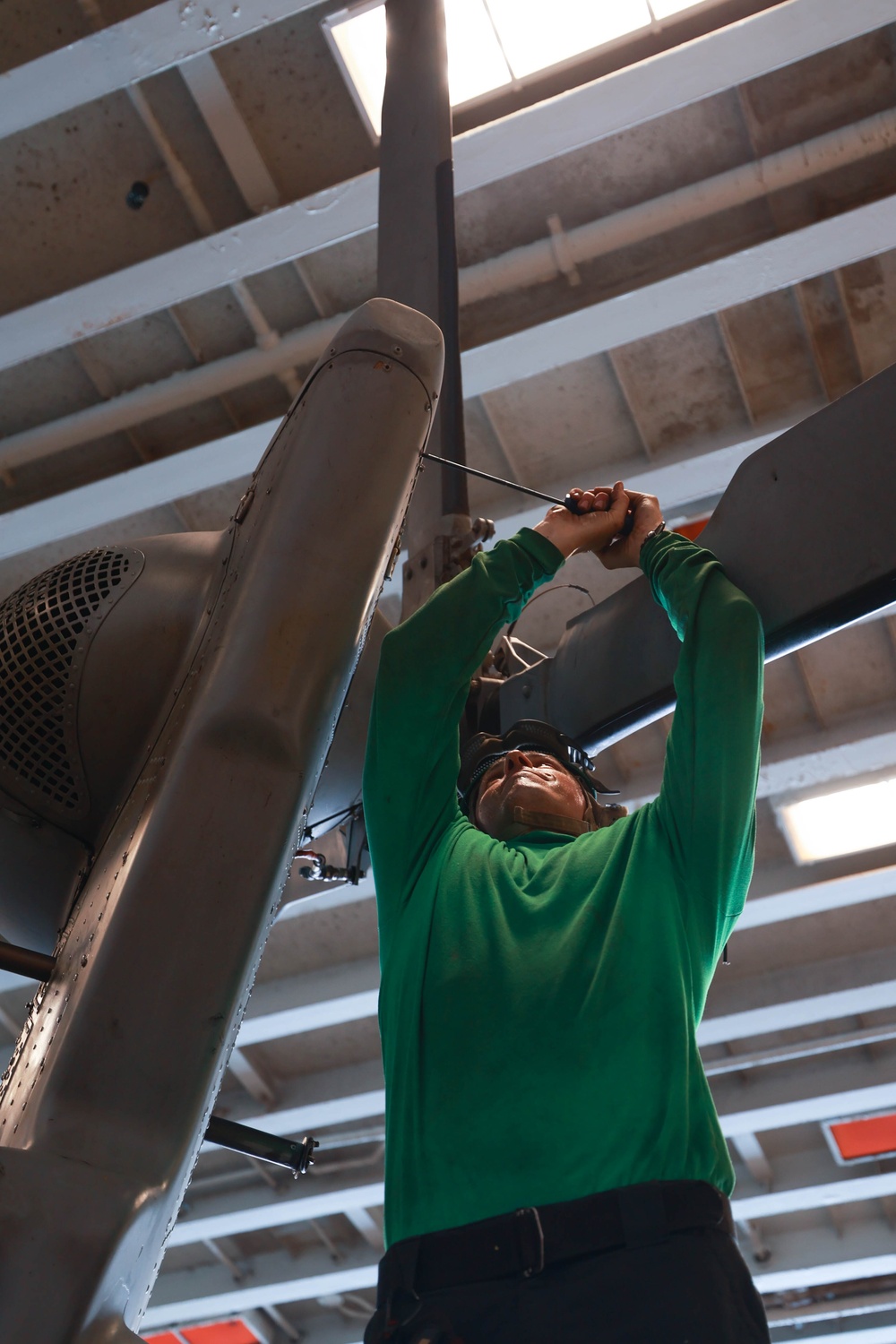 HSC 26 Sailor Perfoms MH-60S Maintenance Aboard USS Bataan