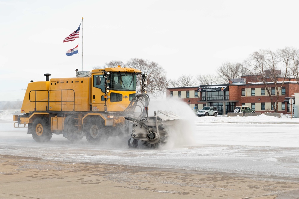 139th members remove snow from flightline, aircraft