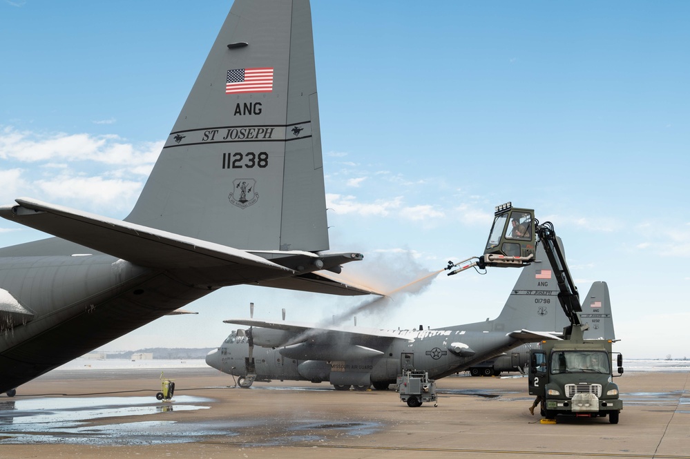 139th members remove snow from flightline, aircraft