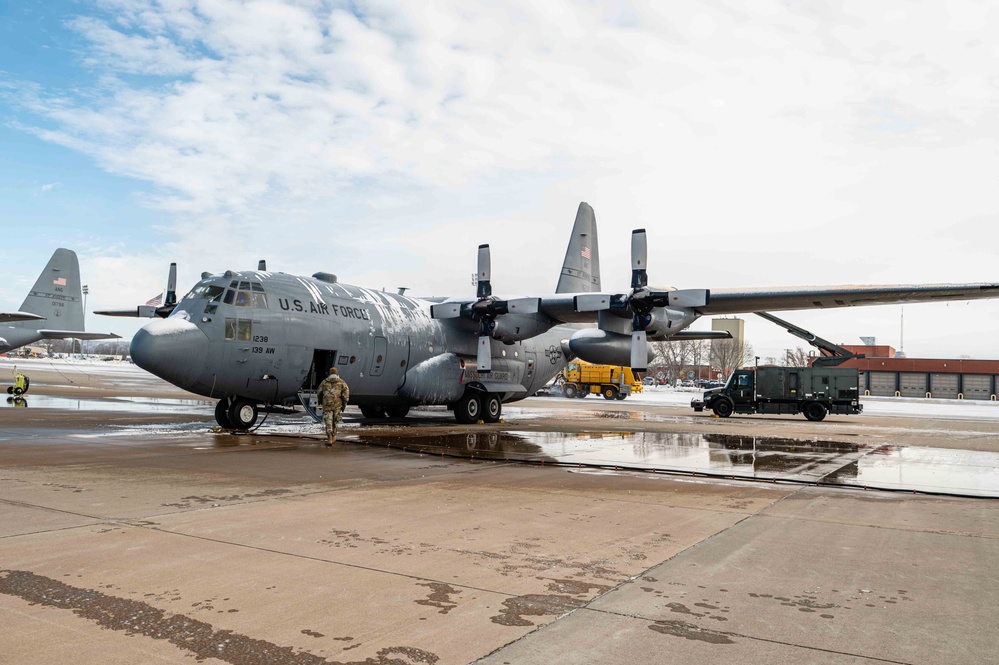 139th members remove snow from flightline, aircraft