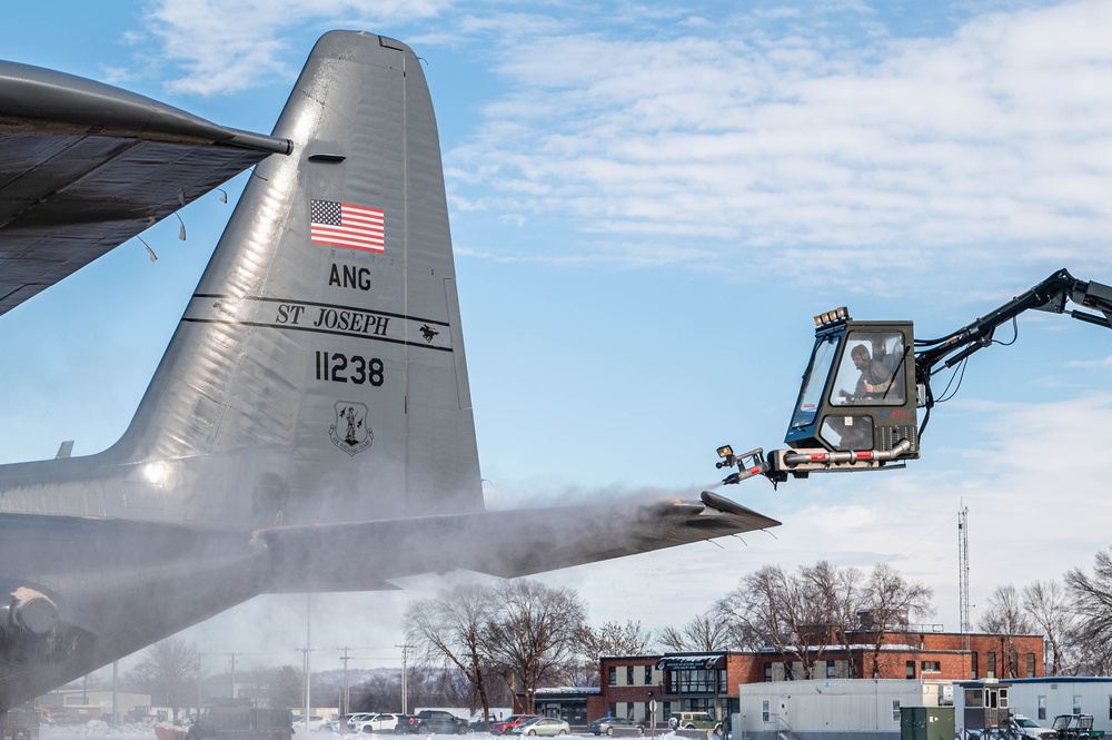 139th members remove snow from flightline, aircraft