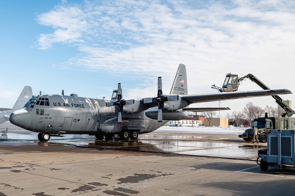 139th members remove snow from flightline, aircraft