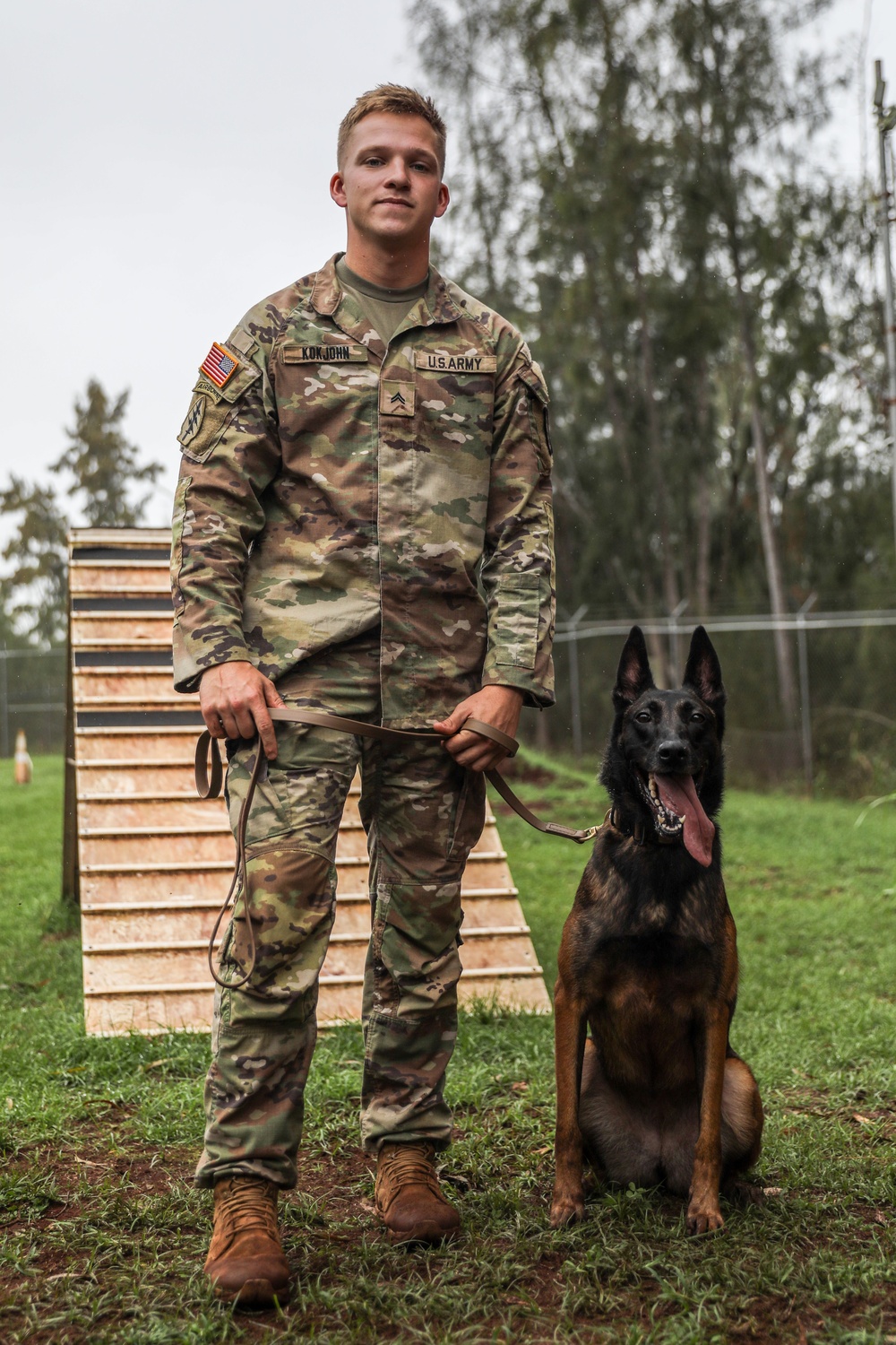 8th Military Police Brigade working dog handler and military working dog, pose for a photo on Scofield Barracks.