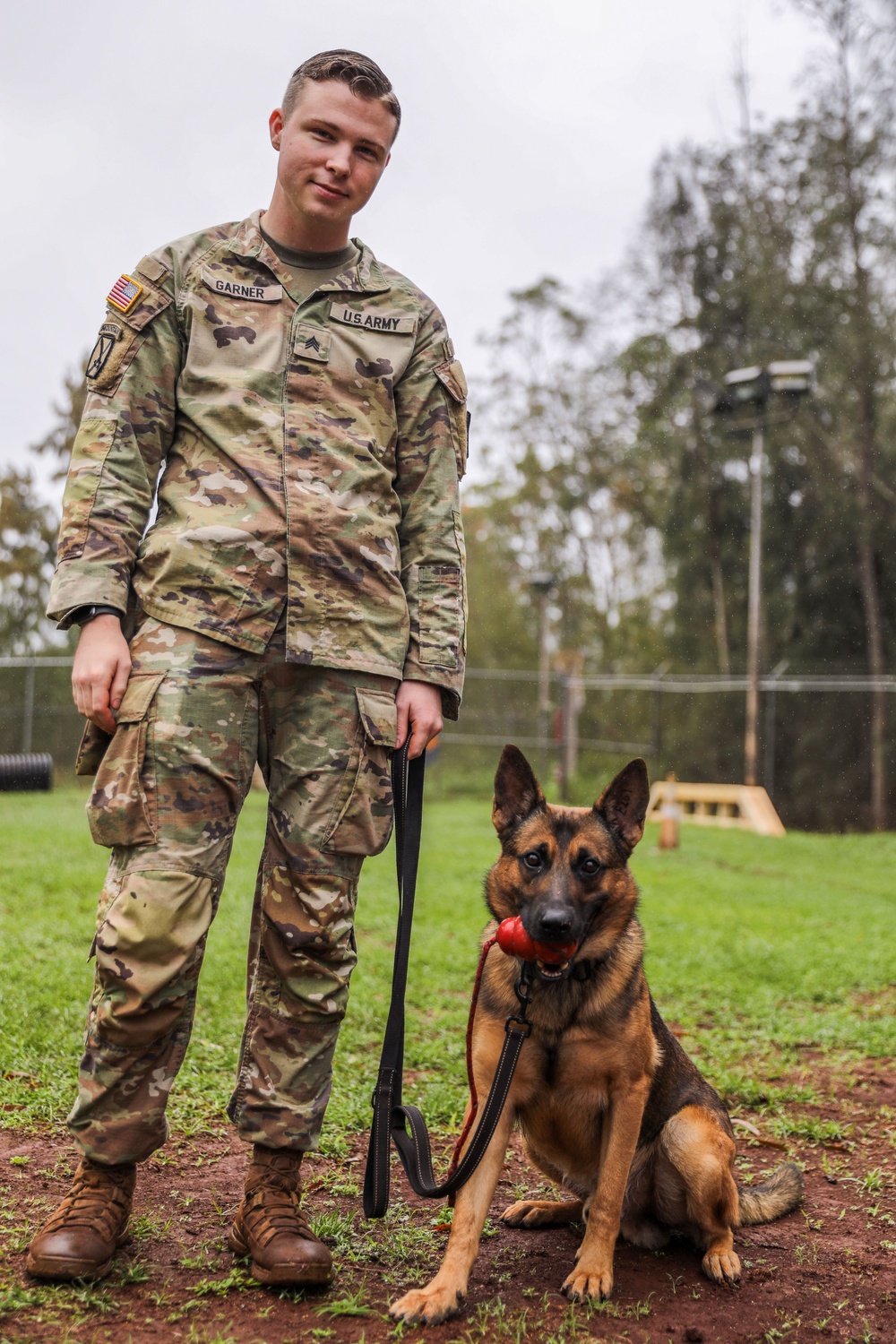 8th Military Police Brigade working dog handler and military working dog, pose for a photo on Scofield Barracks.