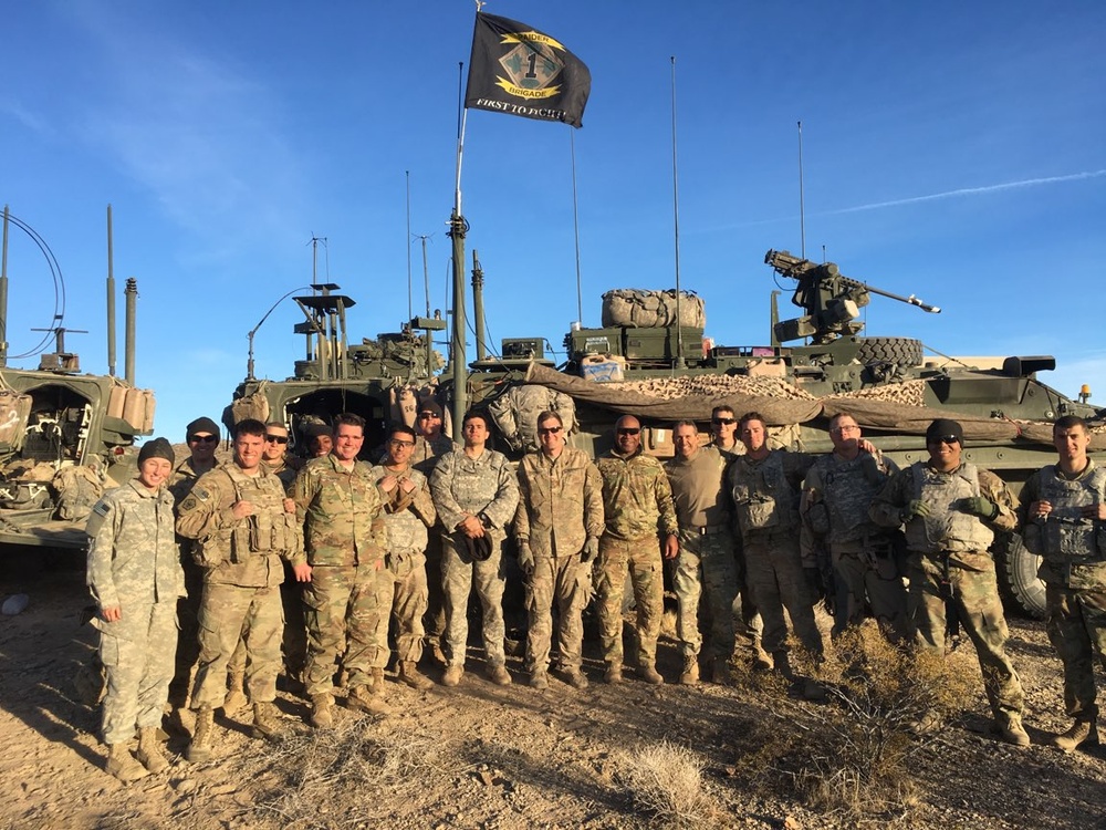 Sgt. 1st Class Erixs Reyes Celebrates Reenlistment poses with his Company after a Successful NTC Rotation
