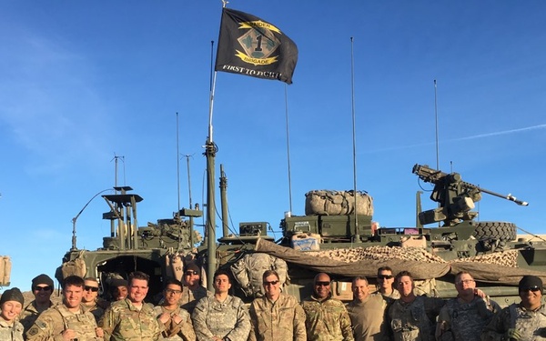 Sgt. 1st Class Erixs Reyes Celebrates Reenlistment poses with his Company after a Successful NTC Rotation