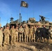 Sgt. 1st Class Erixs Reyes Celebrates Reenlistment poses with his Company after a Successful NTC Rotation