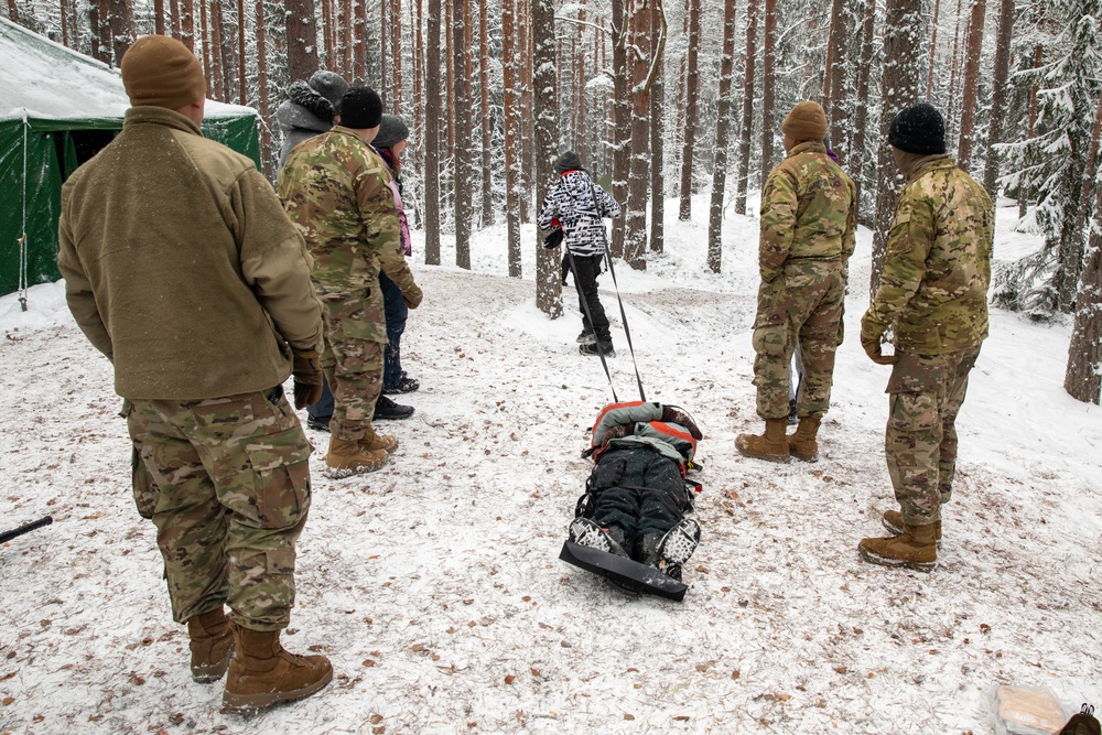 3rd Infantry Division Artillery medics provide first-aid training to children at Latvian winter camp