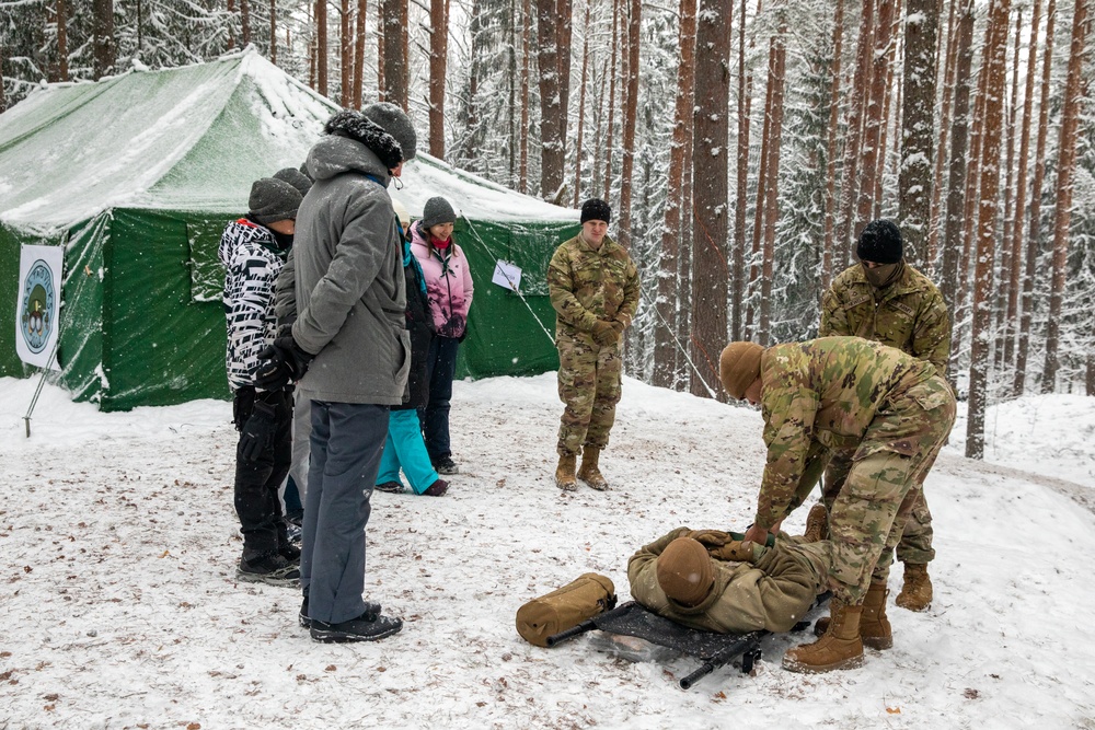 3rd Infantry Division Artillery medics provide first-aid training to children at Latvian winter camp