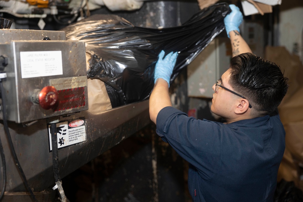 USS Bataan Sailors Sort Trash