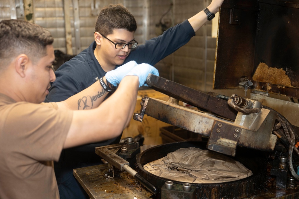 USS Bataan Sailors Sort Trash