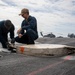 USS Carl Vinson (CVN 70) Sailors Conduct Arresting Gear Maintenance