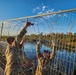 Texas National Guard Engineers install razor wire to barriers
