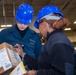 USS Ronald Reagan (CVN 76) Sailors sort supply packages for ship departments