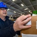 USS Ronald Reagan (CVN 76) Sailors sort supply packages for ship departments