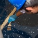 USS Ronald Reagan (CVN 76) Sailors apply clear epoxy