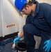 USS Ronald Reagan (CVN 76) Sailors apply clear epoxy