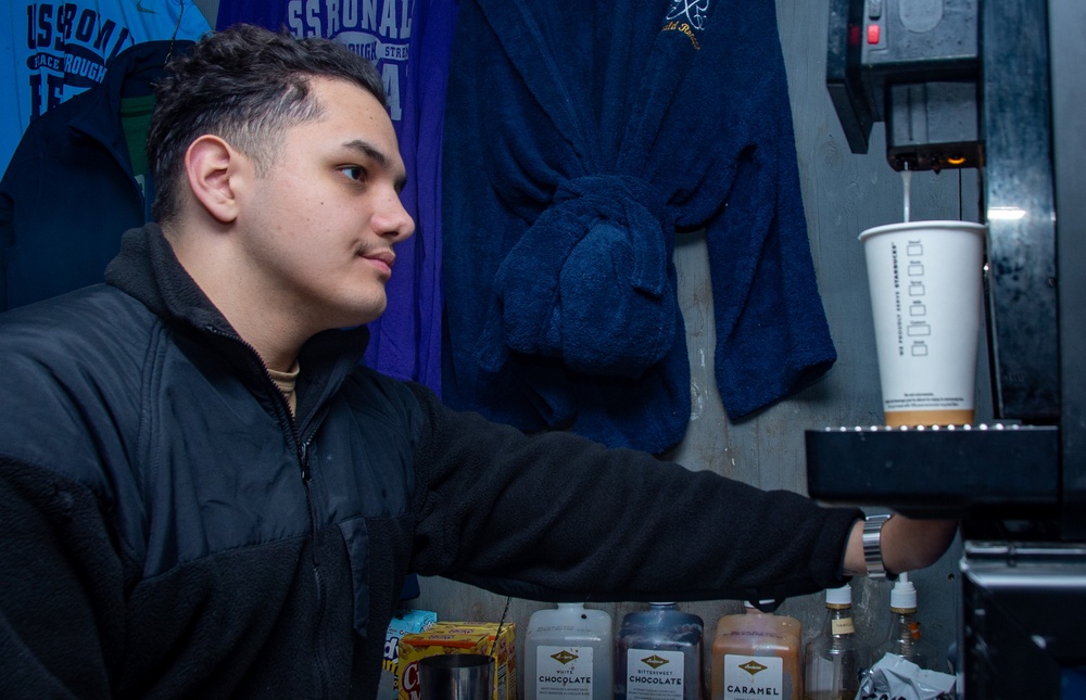 USS Ronald Reagan (CVN 76) Sailor works in hangar bay kiosk