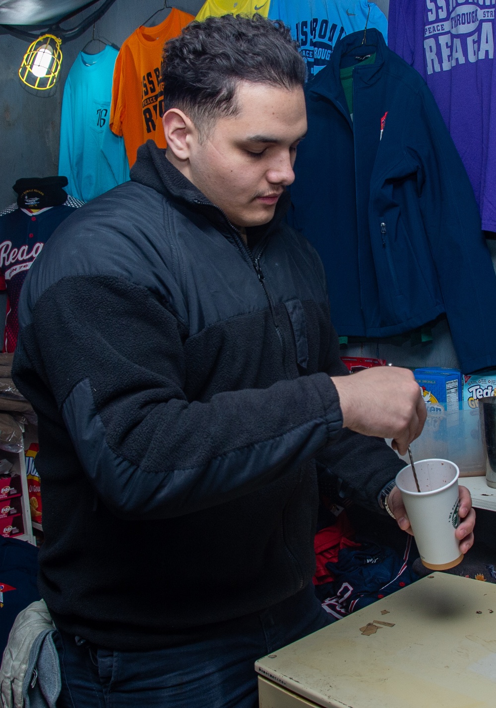 USS Ronald Reagan (CVN 76) Sailor works in hangar bay kiosk