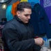 USS Ronald Reagan (CVN 76) Sailor works in hangar bay kiosk
