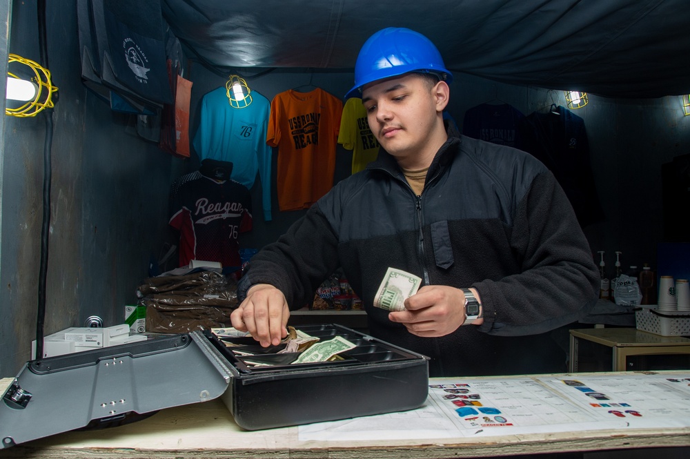 USS Ronald Reagan (CVN 76) Sailor works in hangar bay kiosk
