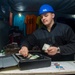 USS Ronald Reagan (CVN 76) Sailor works in hangar bay kiosk