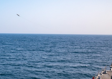 USS Gravely Conducts Fly-by with VAQ-130